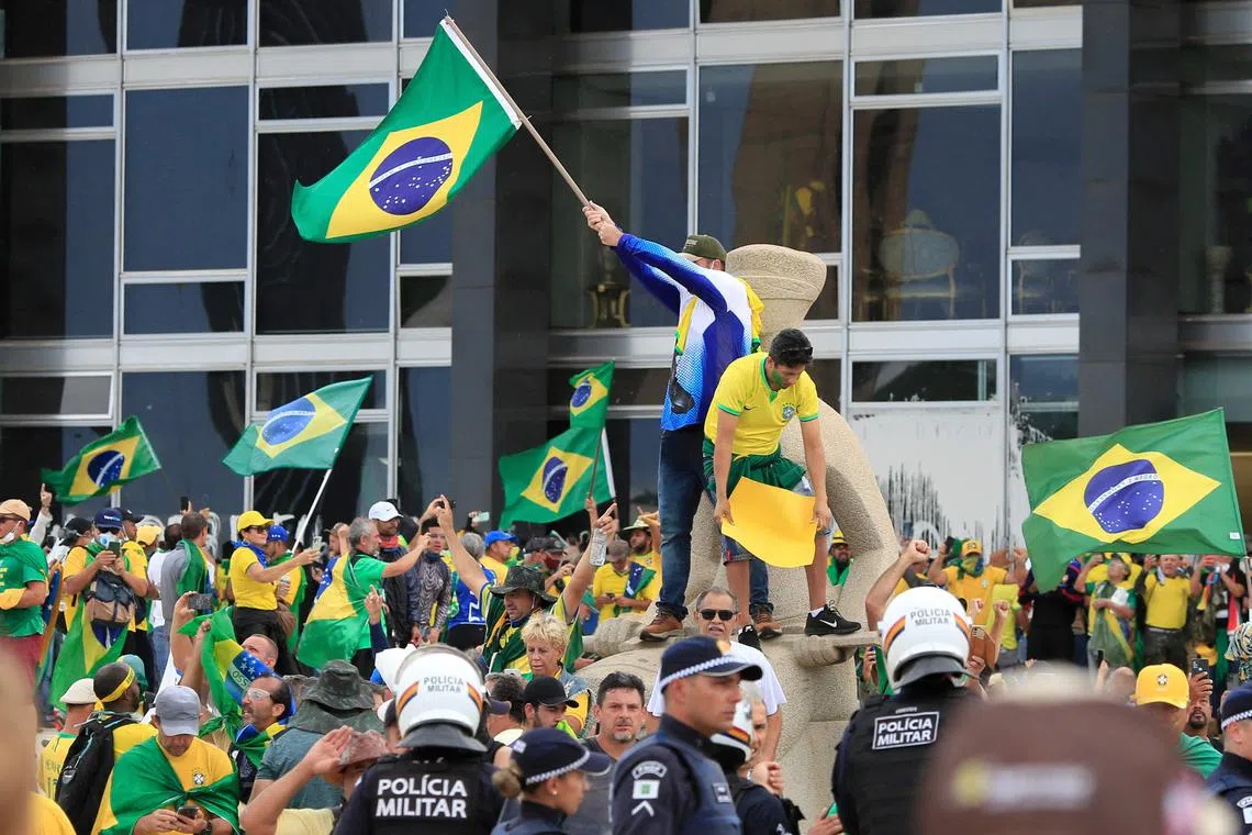 Supporters of Brazilian former President Jair Bolsonaro invade Planalto Presidential Palace in Brasilia after his rival, leftist Luiz Inacio Lula de Silva, took office a week ago. 