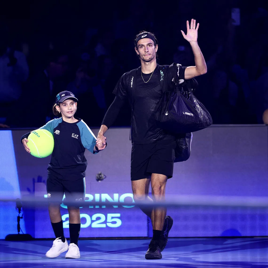 Tennis - ATP Finals - Turin - Palasport Olimpico, Turin, Italy - November 13, 2025 Italy's Lorenzo Musetti arrives on court ahead of his group stage match against Spain's Carlos Alcaraz REUTERS/Guglielmo Mangiapane