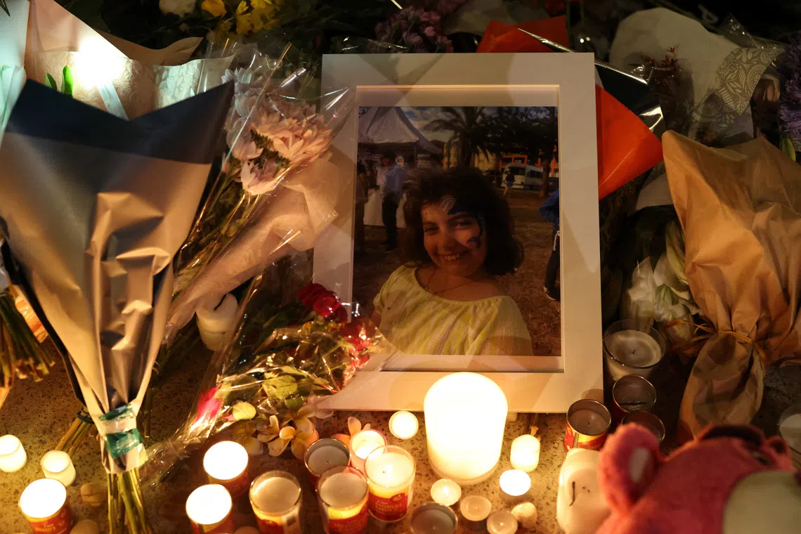 A photograph of Matilda Britvan, 10, a victim of a shooting at Jewish holiday celebration on Sunday at Bondi Beach, lies amongst floral tributes in Sydney, Australia, December 16, 2025. REUTERS/Hollie Adams