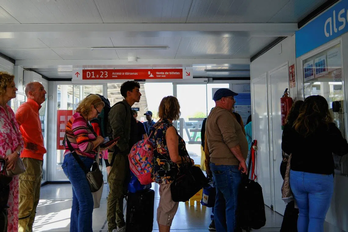 Moroccan migrant Abdelmoujoud Erra, 27, queues to buy a bus ticket to Valladolid, to obtain a vulnerability certificate to regularise migration status, in Almeria Spain, April 22, 2026. REUTERS/Nacho Doce