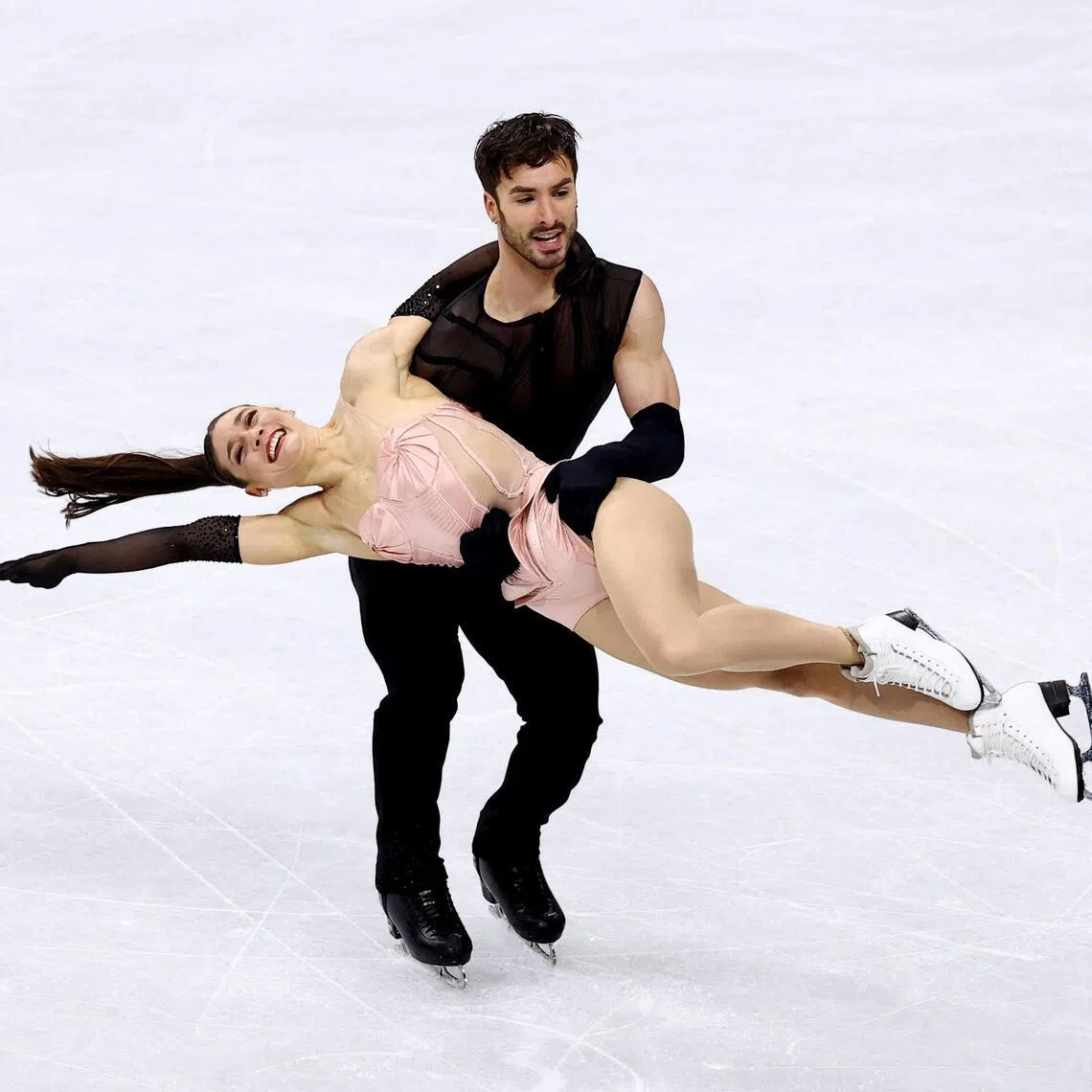 France's Guillaume Cizeron swinging his partner Laurence Fournier Beaudry during the ice dance rhythm dance in the team figure skating event at the Milano Cortina Olympics on Feb 6, 2026.