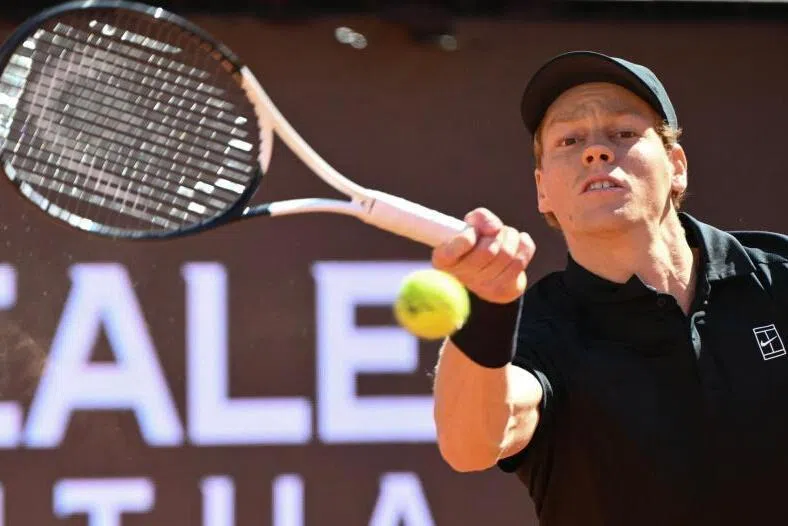 Italy's Jannik Sinner hits a return to Australia's Alexei Popyrin during the ATP Rome Open tennis tournament at Foro Italico in Rome on May 11, 2026.