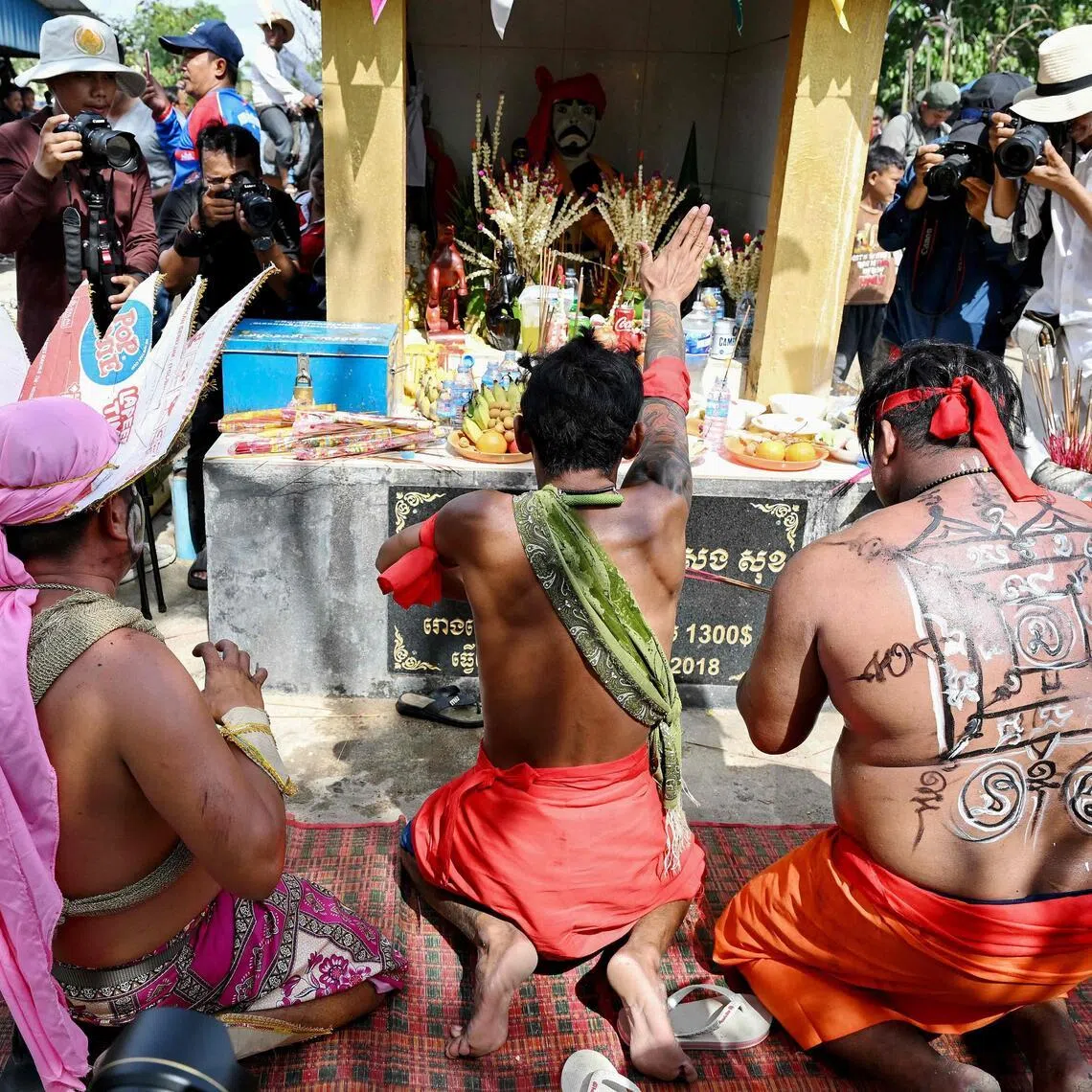 Cambodian revellers praying to the guardian spirit Pring Ka-Ek on the outskirts of Phnom Penh on May 21.