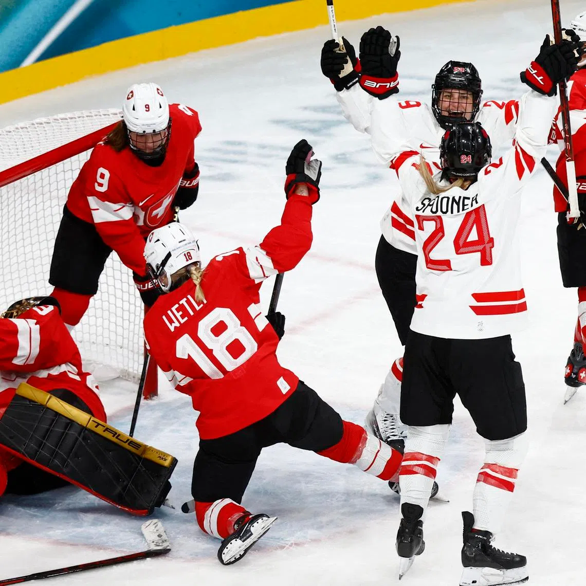 Milano Cortina 2026 Olympics - Ice Hockey - Women's Preliminary Round - Group A - Switzerland vs Canada - Milano Rho Ice Hockey Arena, Milan, Italy - February 07, 2026. Natalie Spooner of Canada celebrates scoring their first goal against Switzerland with Marie-Philip Poulin of Canada REUTERS/Alessandro Garofalo