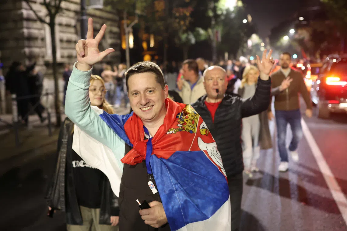 Supporters of the electoral list "Student List - Students Win" celebrate after long-time ruler Aleksandar Vucic conceded defeat in the parliamentary election, in Belgrade, Serbia, October 25, 2026. REUTERS/Djordje Kojadinovic