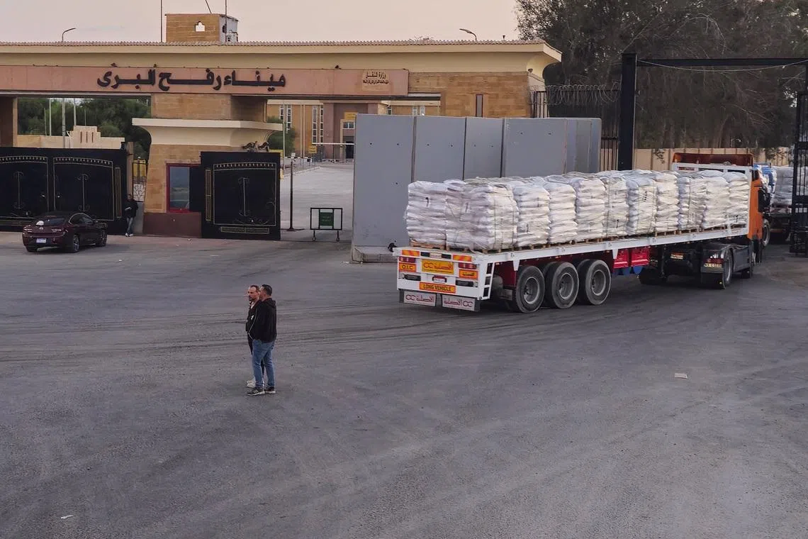 Trucks carrying humanitarian aid enter the crossing into the Gaza Strip at the Rafah border on the Egypt side, amid a ceasefire between Israel and Hamas in Gaza, in Rafah, Egypt, October 17, 2025. REUTERS/Stringer/File Photo