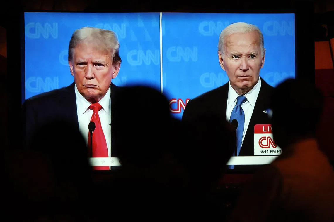 A live screening by CNN of the presidential debate between US President Joe Biden (right) and Republican presidential candidate former President Donald Trump at a debate watch party on June 27.
