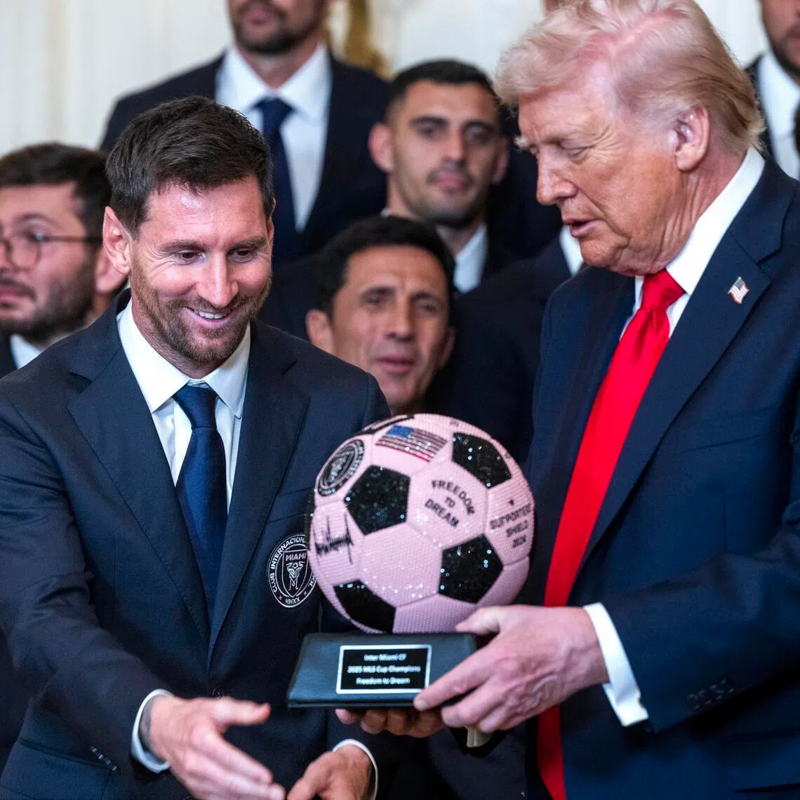 Inter Miami forward Lionel Messi giving US President Donald Trump a gift as Mr Trump welcomes the Major League Soccer champions to the White House on March 5.