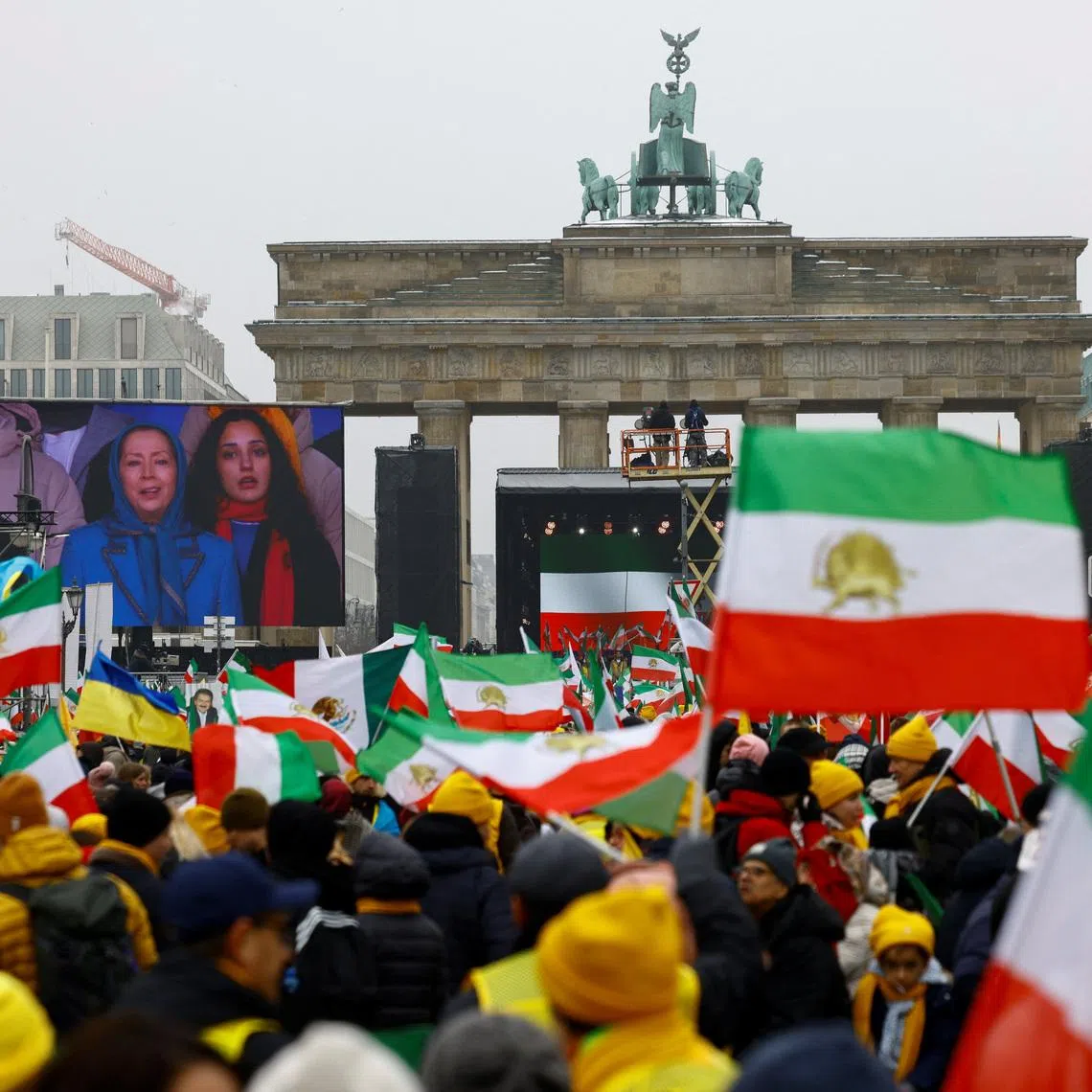 Demonstrators watch on screen Iranian opposition leader Maryam Rajavi speaking on stage, during a protest organized by supporters of the Iranian opposition group, the National Council of Resistance of Iran, to demand an immediate stop to the violence against protesters in Iran and an end to detentions and repression, in Berlin, Germany, February 7, 2026. REUTERS/Axel Schmidt