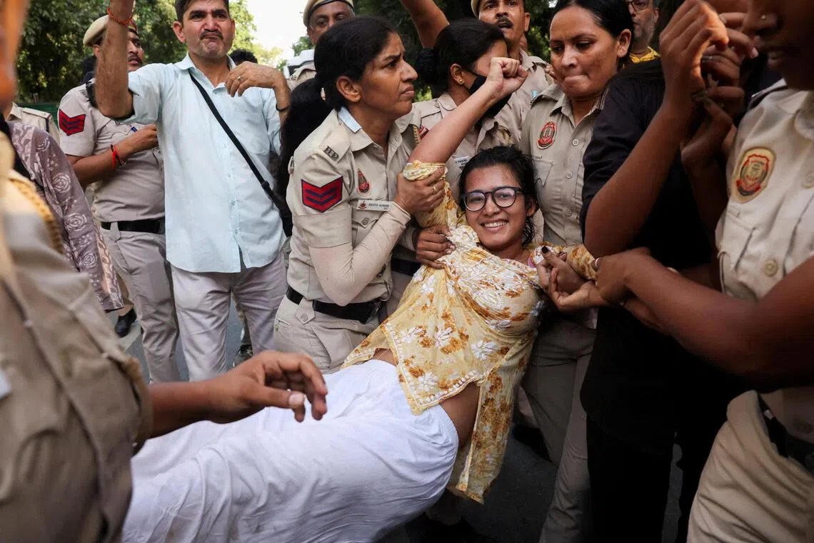 Neha Bora, National President of the All India Students’ Association, reacts as she is detained by police during a protest in New Delhi, Oct 4.