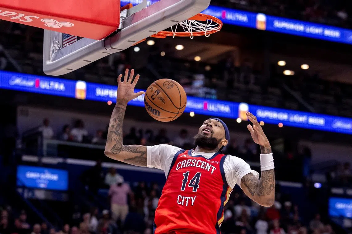 FILE PHOTO: Oct 23, 2024; New Orleans, Louisiana, USA;  New Orleans Pelicans forward Brandon Ingram (14) dunks the ball against Chicago Bulls guard Zach LaVine (8) during the second half at Smoothie King Center. Mandatory Credit: Stephen Lew-Imagn Images/File Photo