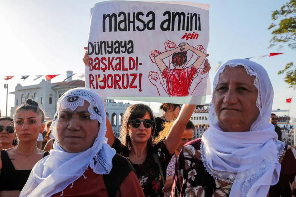 FILE PHOTO: Women take part in a rally on the first anniversary of the death of Mahsa Amini which prompted protests across the country, in Istanbul, Turkey September 16, 2023. Banner reads, \"We revolt against world for Mahsa Amini\".  REUTERS/Dilara Senkaya/File Photo