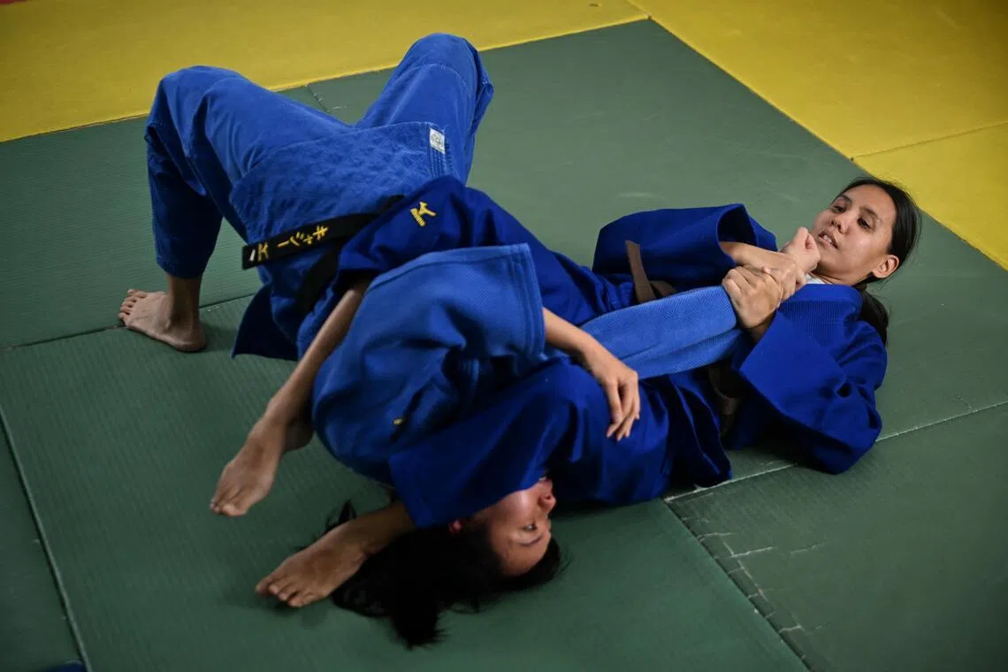 Judoka Joan Hung (right) who is visually impaired, sparring with Cassiopeia Lim, coach and national athlete in wrestling and sport sambo.