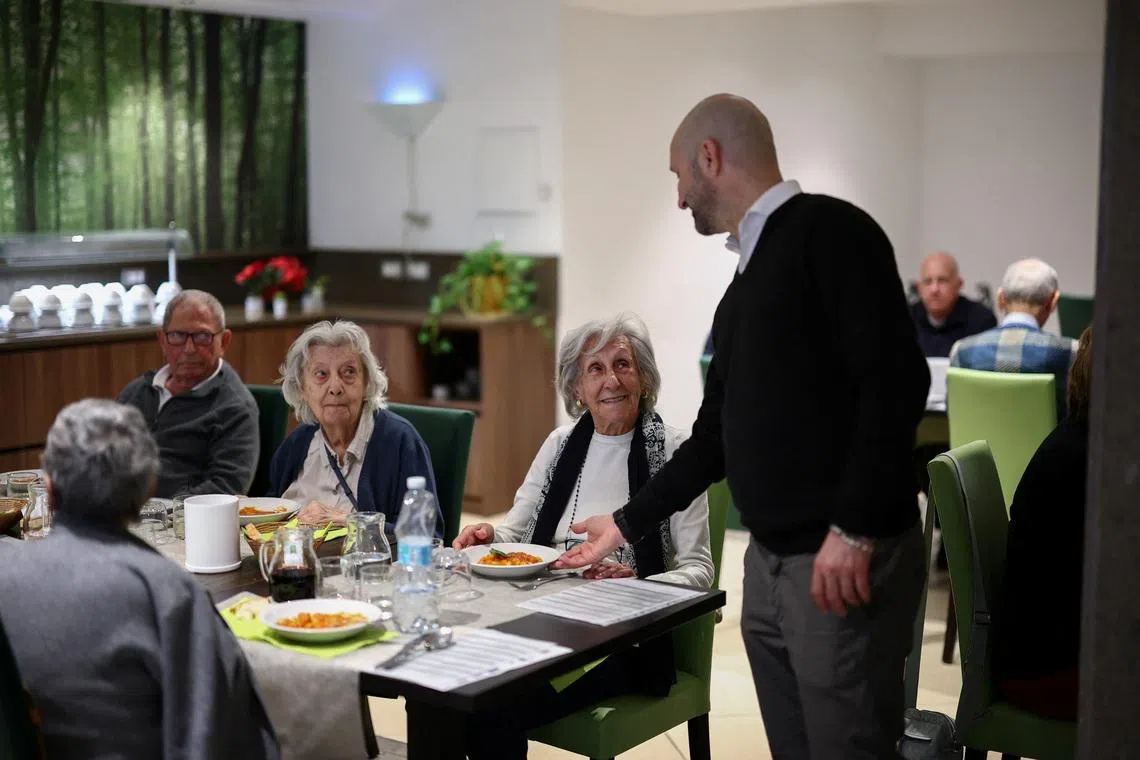 Resident at \"Aris Senior Living\" Giuliana Gorini, 93, is served a dish of pasta during lunch at the facility in Rome, Italy, March 19, 2026. REUTERS/Guglielmo Mangiapane