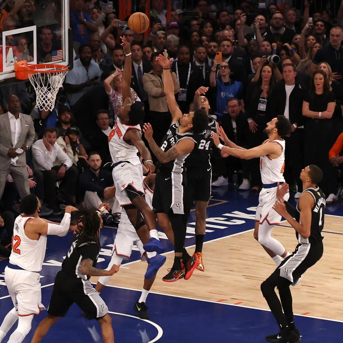 Jun 10, 2026; New York, New York, USA; New York Knicks forward Og Anunoby (8) scores on a rebound against San Antonio Spurs guard Dylan Harper (2) in the fourth quarter during game four of the 2026 NBA Finals at Madison Square Garden. Mandatory Credit: Geoff Burke-Imagn Images