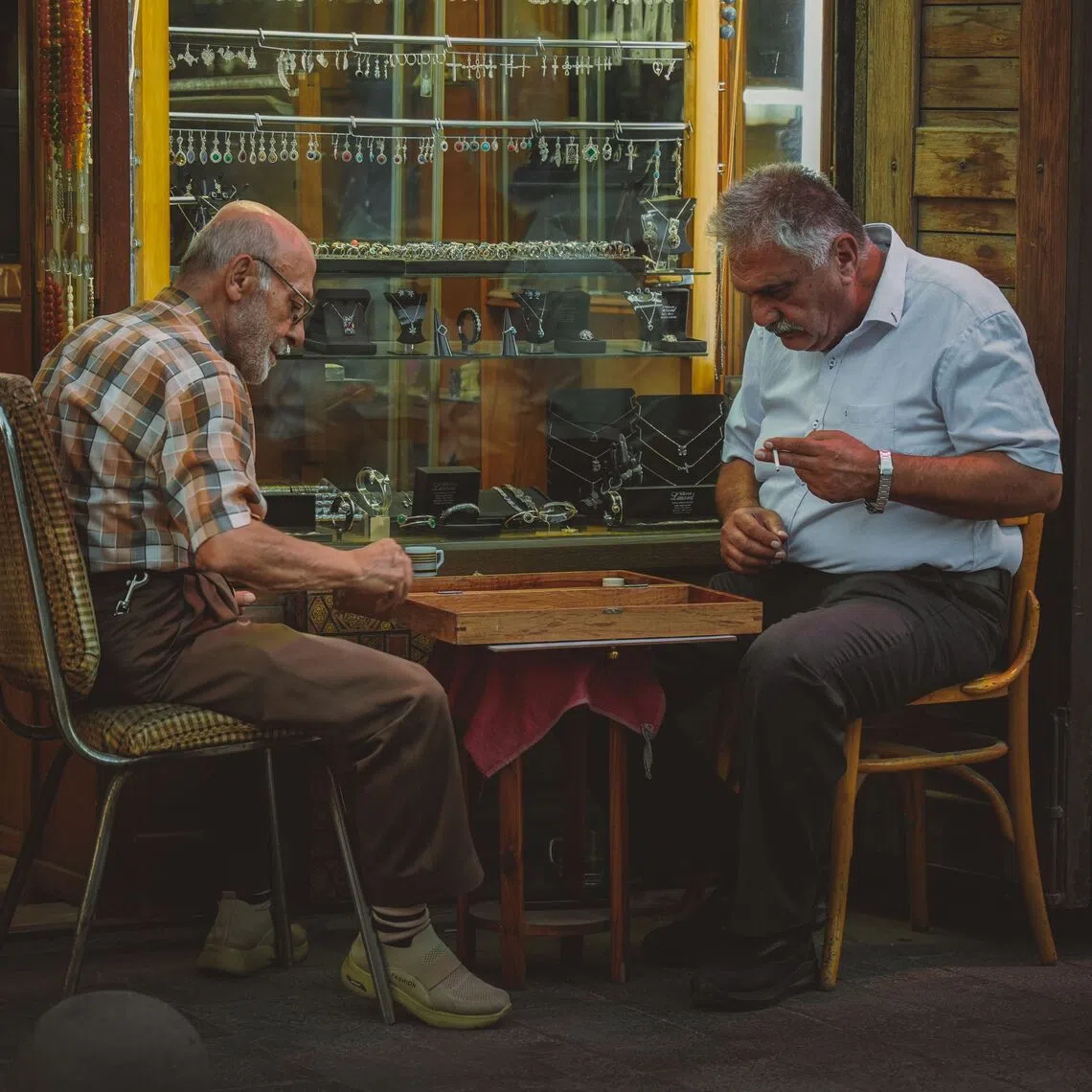 A game of backgammon outside a store in Damascus, Syria. Tourist numbers in Syria more than doubled year-on-year in the first half of 2026 to 3.52 million.