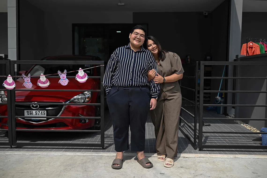 This photo taken on January 12, 2025 shows Niramon "New" Kvunkaew (R) and Karisa "Fah" Loywisut outside of their home in Bangkok. Hundreds of LGBTQ+ couples are set to marry in Thailand on January 23, as the country makes history by becoming the first country in Southeast Asia to legalise same sex marriage. (Photo by Lillian SUWANRUMPHA / AFP) / TO GO WITH Thailand-law-gender-marriage, FOCUS by Montira RUNGJIRAJITTRANON and Watsamon TRI-YASAKDA