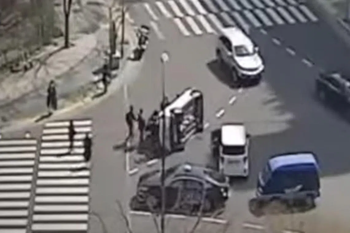 As some people begin to push the vehicle back up, other passers-by and drivers dashed to pitch in.