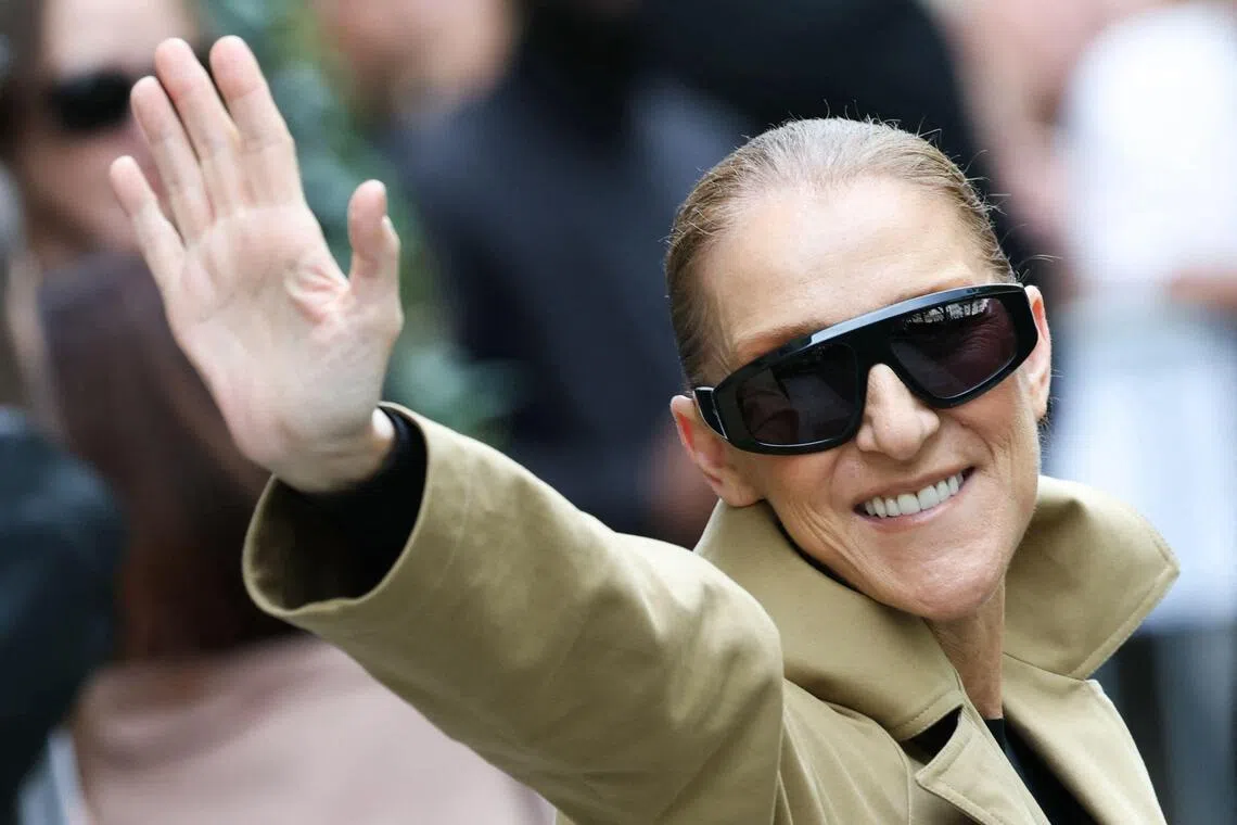 Canadian singer Celine Dion acknowledges fans as she arrives at Hotel Le Royal Monceau in Paris on Aug 28.