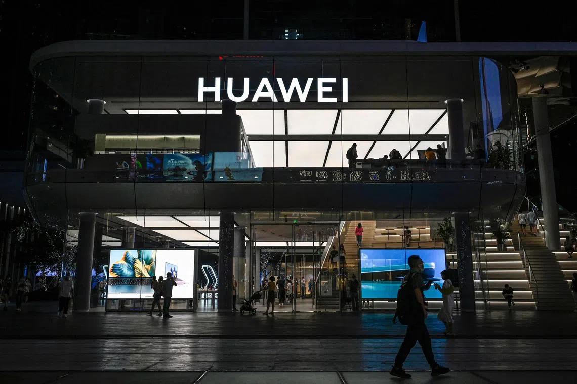 (FILES) This file photo taken on July 12, 2022 shows the Huawei flagship store in Shenzhen, China's southern Guangdong province. - Revenue at Chinese telecom giant Huawei fell by 2.2 percent in the first three quarters of 2022, company data showed October 27, 2022, as Covid-19 and US sanctions dragged down sales. (Photo by Jade GAO / AFP)