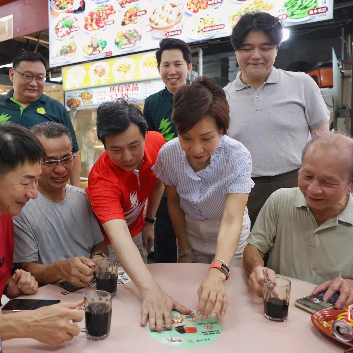 Minister for Sustainability and the Environment Grace Fu (foreground, second from right) and Sembawang GRC MP Gabriel Lam (foreground, centre) launching a support scheme called Brew Specials at 313 KPT coffeeshop at Block 313A Sembawang Drive on June 6.
