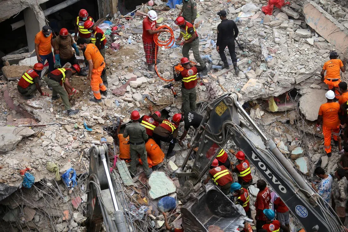 Rescuers search among the rubble at the site of a building collapse in Karachi, Pakistan, on July 5, 2025.