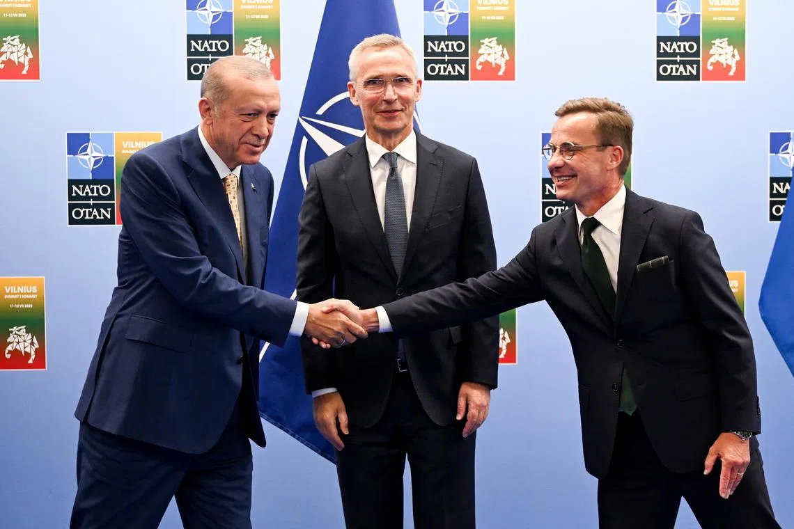 Turkish President Tayyip Erdogan (left) and Swedish Prime Minister Ulf Kristersson shake hands with Nato chief Jens Stoltenberg looking on, in Vilnius on Monday. 