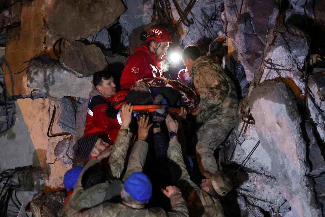 Cennet Sucu is rescued from the rubble of a collapsed hospital, following an earthquake in Iskenderun, Turkey, Feb 6, 2023. 