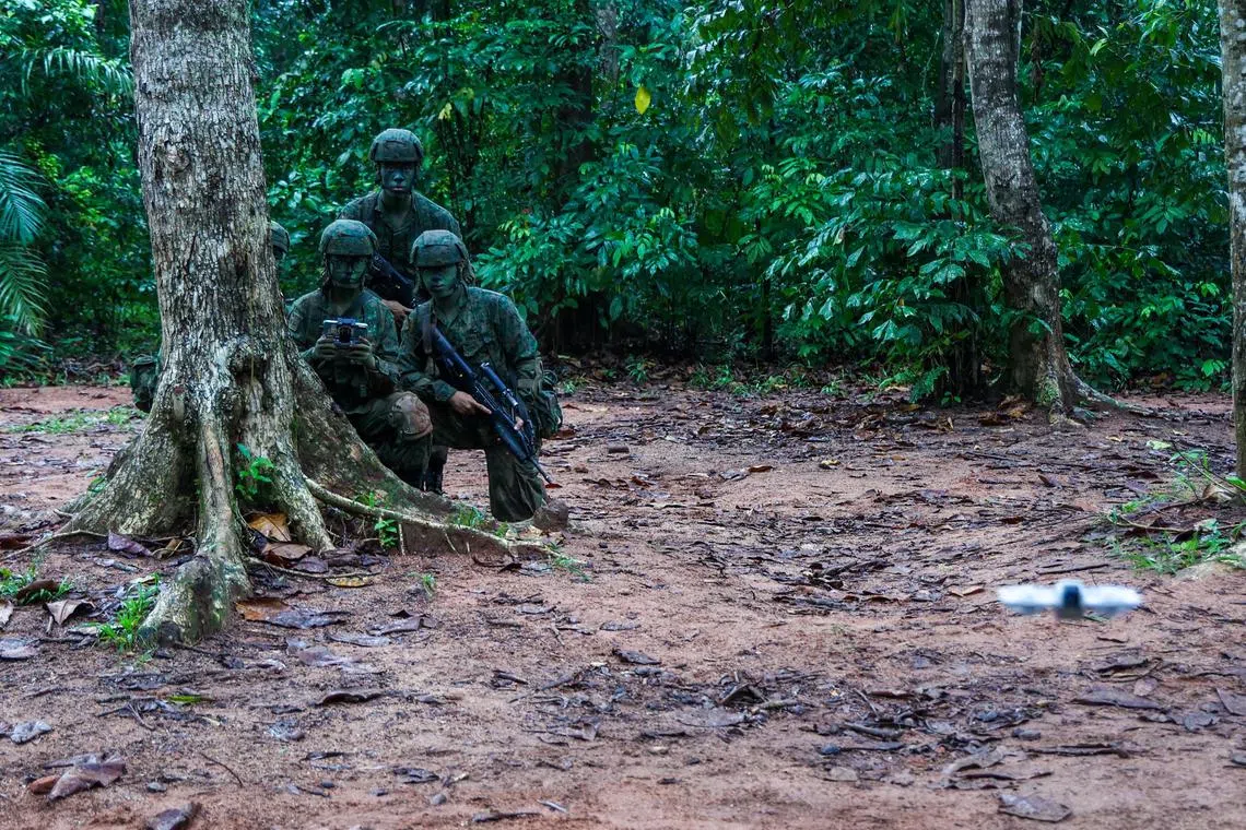 Basic Military Training Centre recruits on Pulau Tekong flying the Chinese-made DJI Neo in a demonstration exercise on Aug 4. 