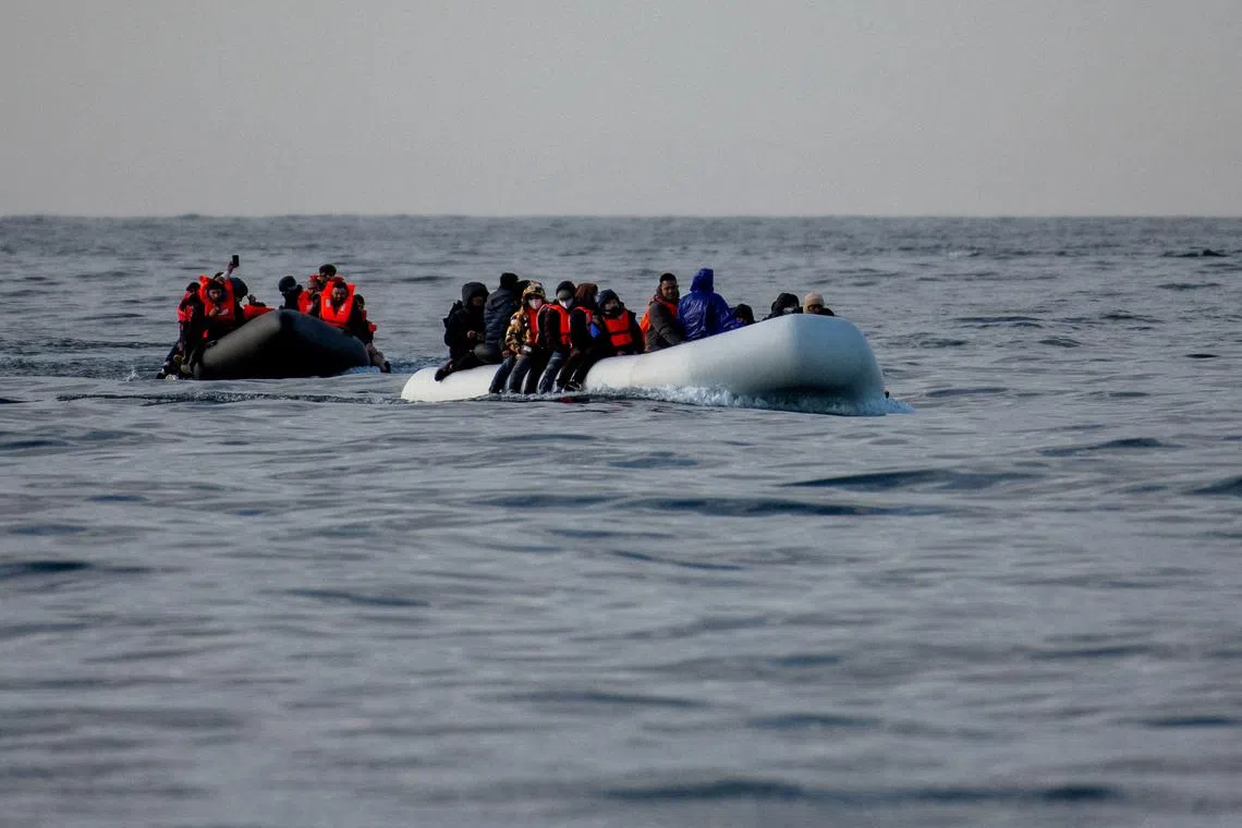 FILE PHOTO: Two inflatable dinghies carrying migrants make their way towards England in the English Channel, Britain, May 4, 2024. REUTERS/Chris J. Ratcliffe/File Photo