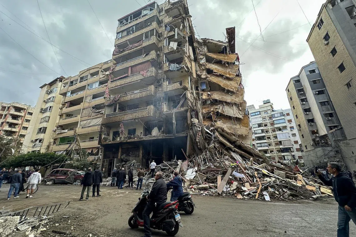 epa11739425 People inspect the site of an Israeli airstrike on the Tayouneh area, south of Beirut, Lebanon, 25 November 2024. According to the Lebanese Ministry of Health, more than 3,750 people have been killed and more than 15,600 others injured in Lebanon since the escalation in hostilities between Israel and Hezbollah.  EPA-EFE/WAEL HAMZEH