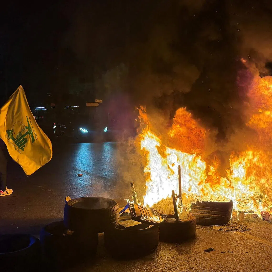 Hezbollah supporters blocking the old airport road in the southern suburbs of Beirut with burning tyres to protest against the trilateral agreement that was signed between the US, Israel and Lebanon.