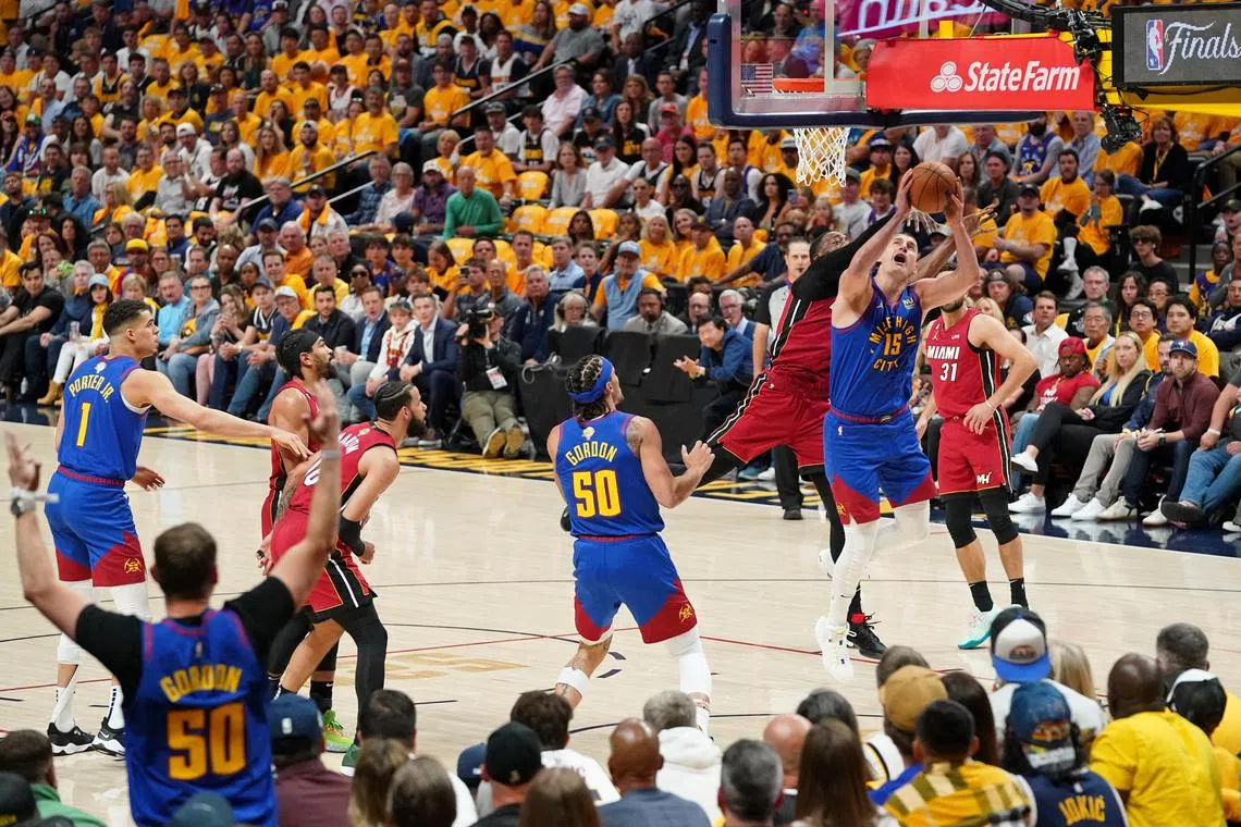 Denver Nuggets centre Nikola Jokic battles for the ball against Miami Heat centre Bam Adebayo in Game 1 of the NBA Finals.