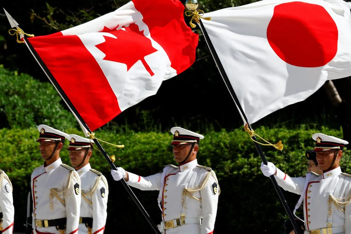 Japanese honour guards hold the national flags of Canada and Japan during a ceremony for Canadian Defence Minister Bill Blair at the Ministry of Defense in Tokyo, Japan September 13, 2024. REUTERS/Kim Kyung-Hoon