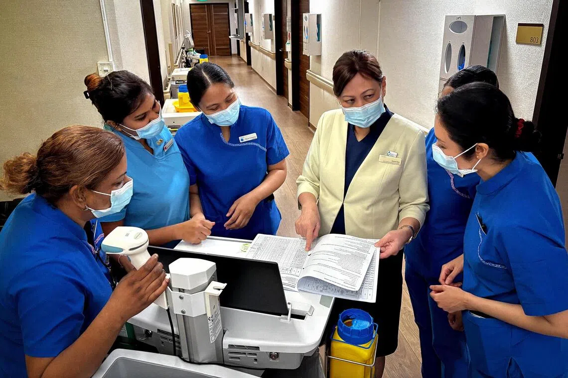 Assistant director of nursing at Gleneagles Hospital Susan Kok (centre) continues working beyond retirement age, as she enjoys passing on her healthcare knowledge to younger colleagues.