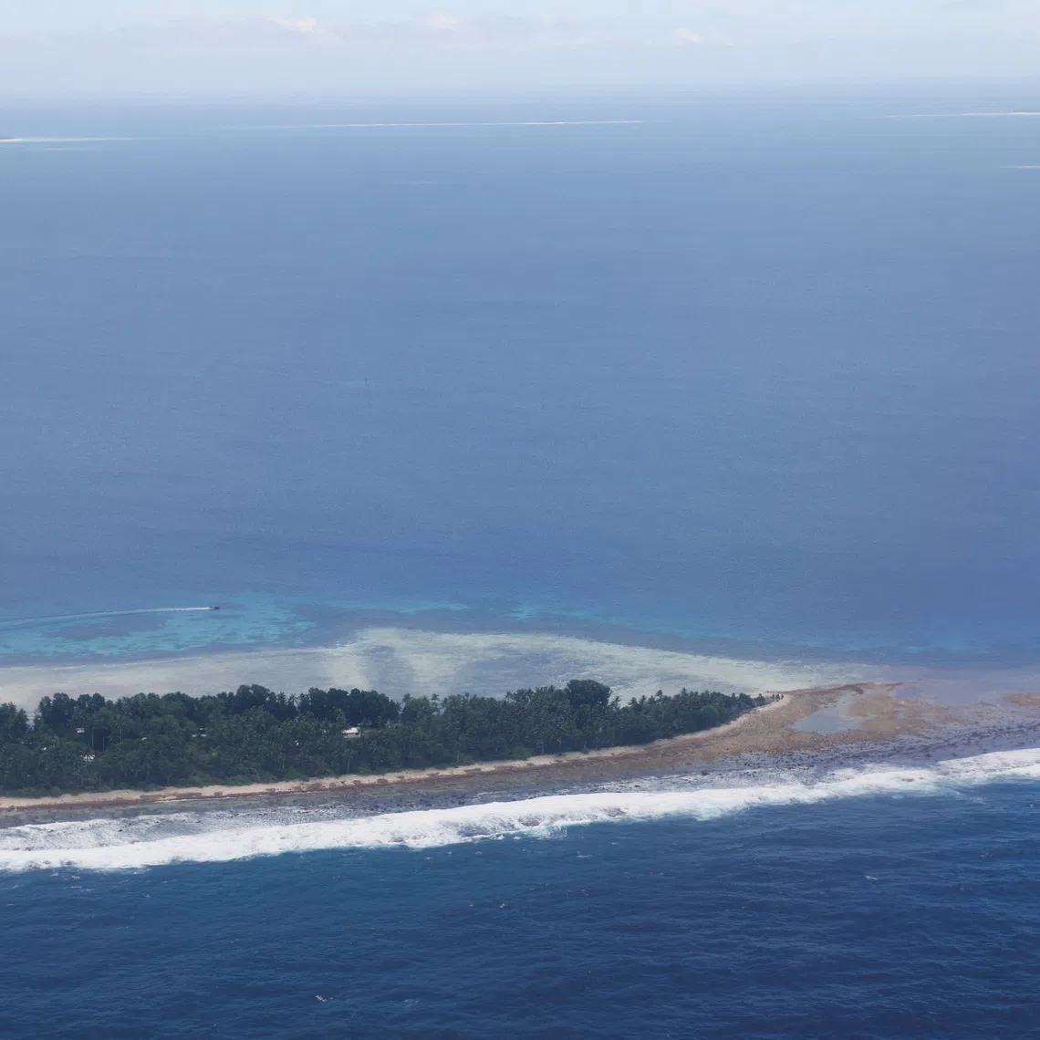 FILE PHOTO: An aerial view of the Pacific Islands nation of Tuvalu, September 6, 2024. Rising sea levels caused by climate change have prompted the Tuvalu government to strike a climate migration pact with Australia. REUTERS/Kirsty Needham/File Photo