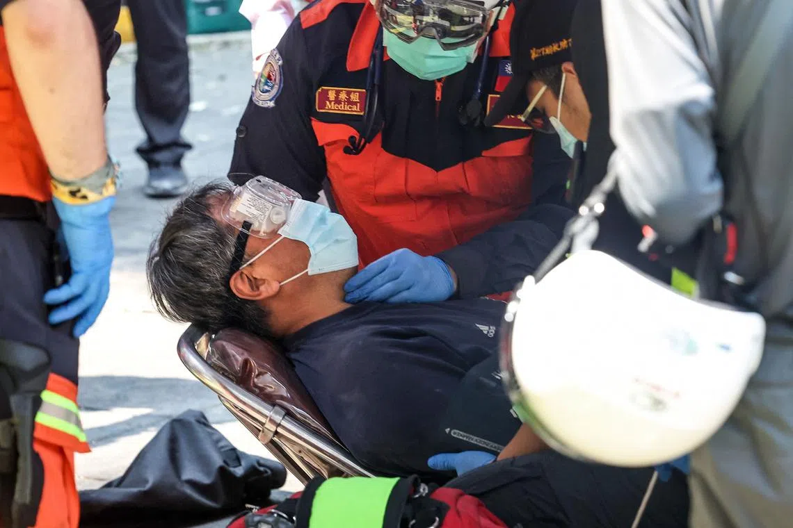 Emergency workers attending to an earthquake survivor who had been trapped in a damaged building in New Taipei City on April 3, 2024. 