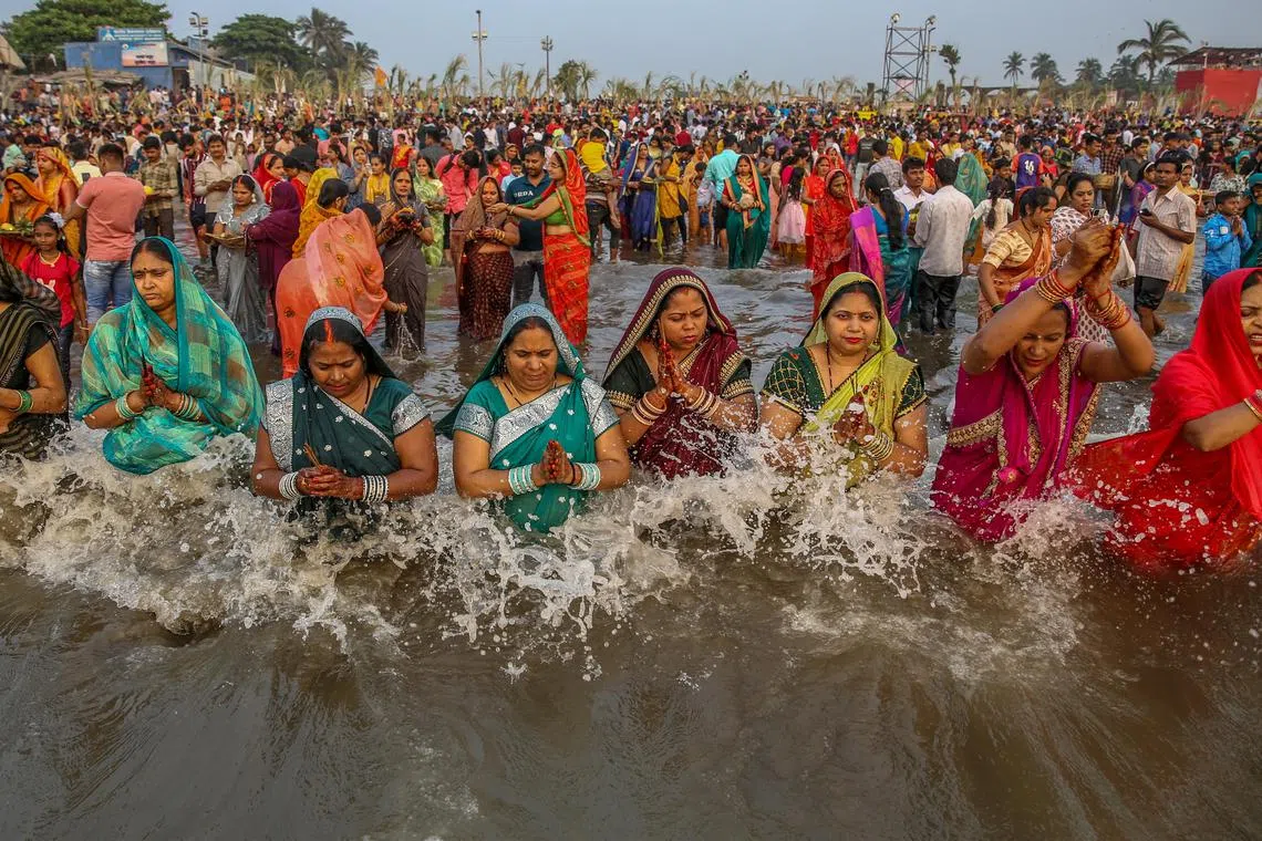 Hindu devotees performing rituals and offer prayers to the Sun God on the occasion of the Hindu festival 'Chhath Puja' at Juhu beach in Mumbai, India onNov 19,  2023. 