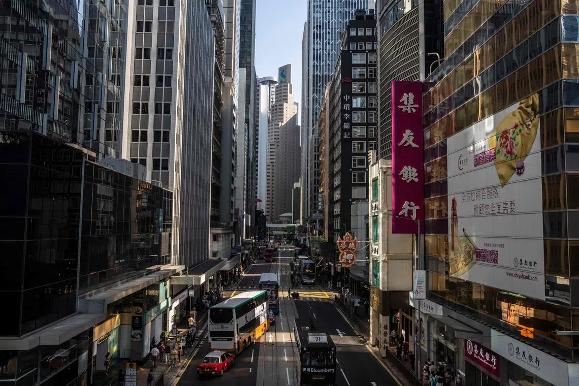 The Standard Chartered building (C) is seen in Hong Kong on October 28, 2022. - Hundreds of top bankers will take part in a summit in Hong Kong next week as the city prepares to reopen for business after the pandemic. (Photo by ISAAC LAWRENCE / AFP)