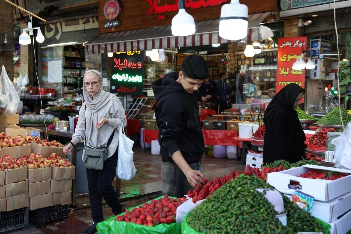 Iranians shop in a bazaar in Tehran, Iran, on March 24. 