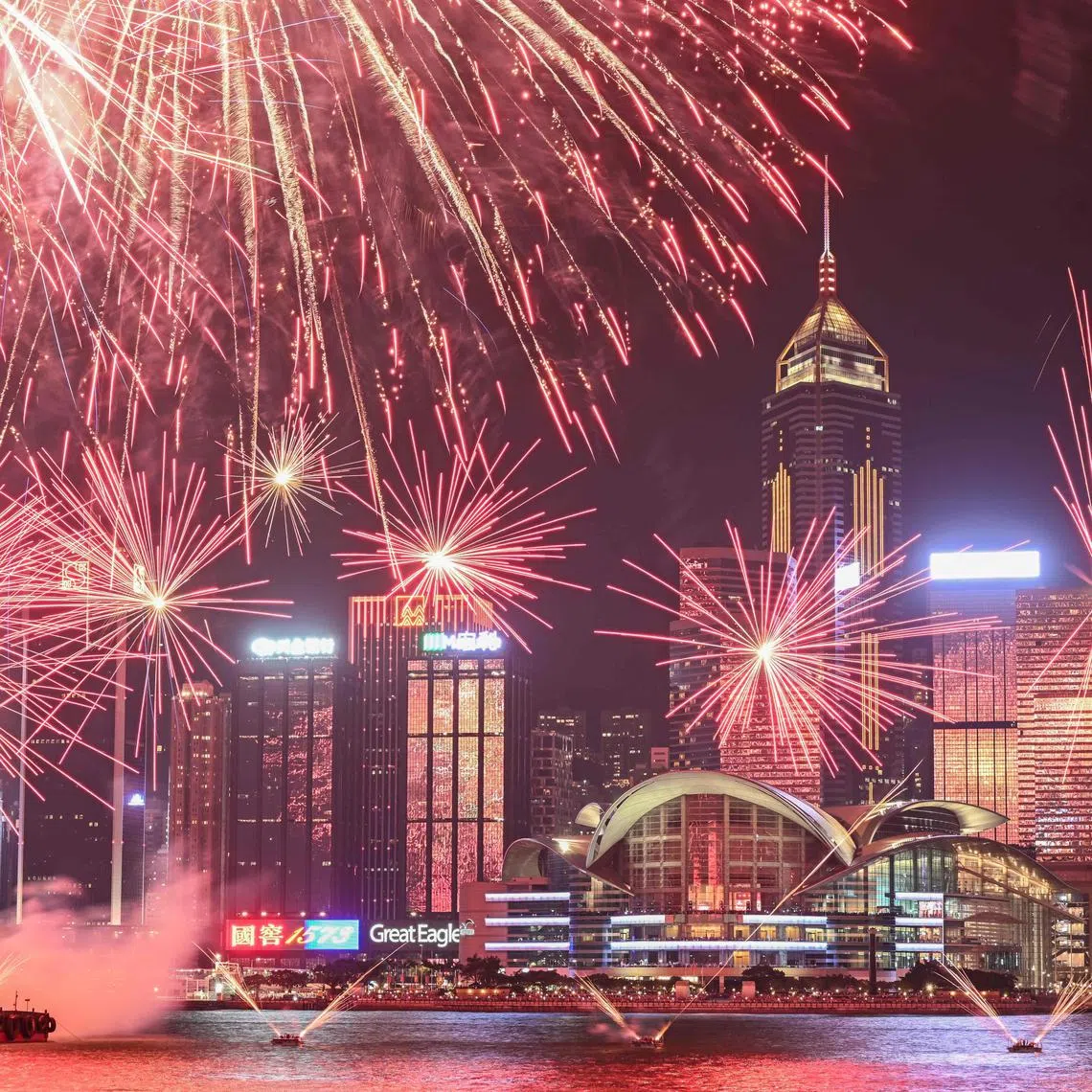 TOPSHOT - Fireworks light up over Victoria Harbour to commemorate China's National Day in Hong Kong on October 1, 2024. (Photo by Peter PARKS / AFP)