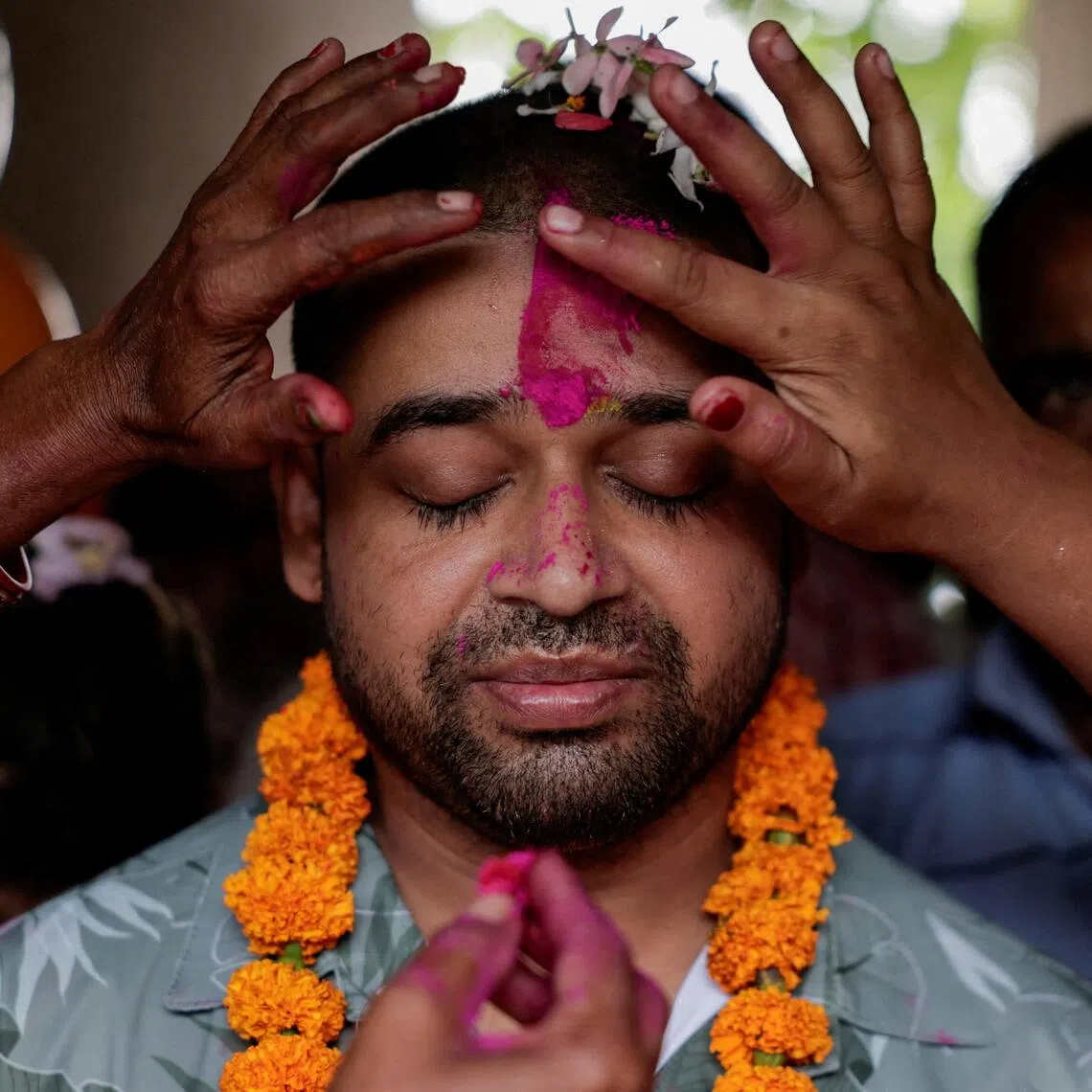 Family members offers tika to Sanjay Sah, a survivor pulled out alive after spending nine days trapped in a hydropower station tunnel, upon his arrival in Tilathi Koiladi village in Saptari District, on Sept 13.
