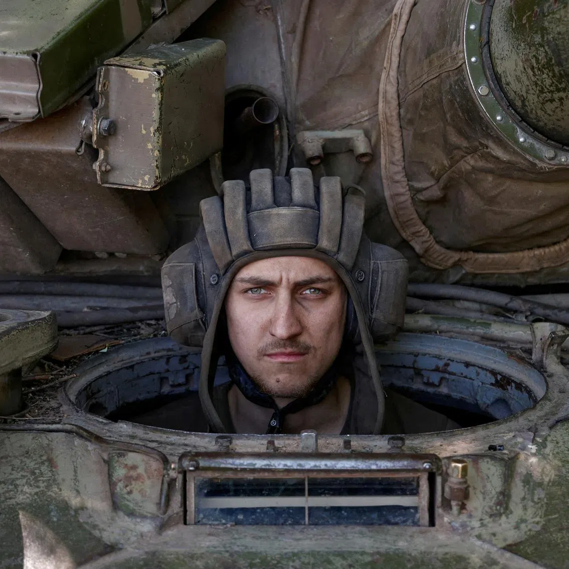 A Ukrainian serviceman looks on from inside a tank at a position in Donetsk region, as Russia's attack on Ukraine continues, June 11, 2022. 