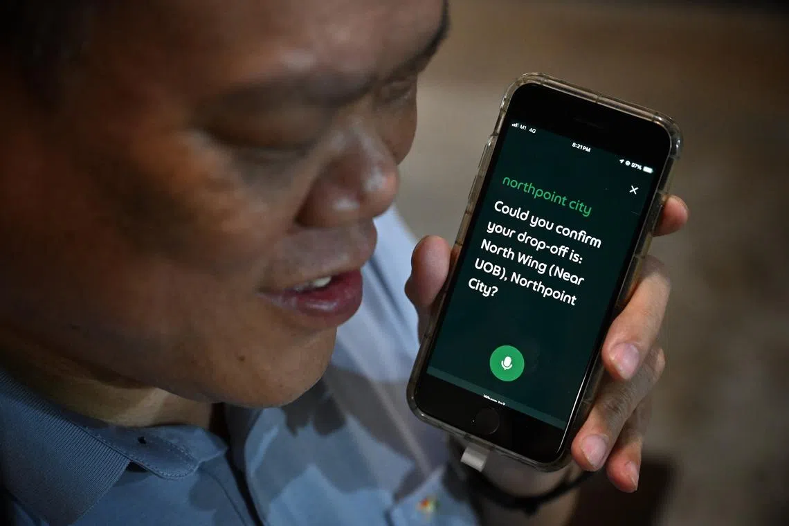 Peter Lim, who is visually impaired, uses the AI voice assistant to book a Grab ride from his home to a nearby mall on July 18.