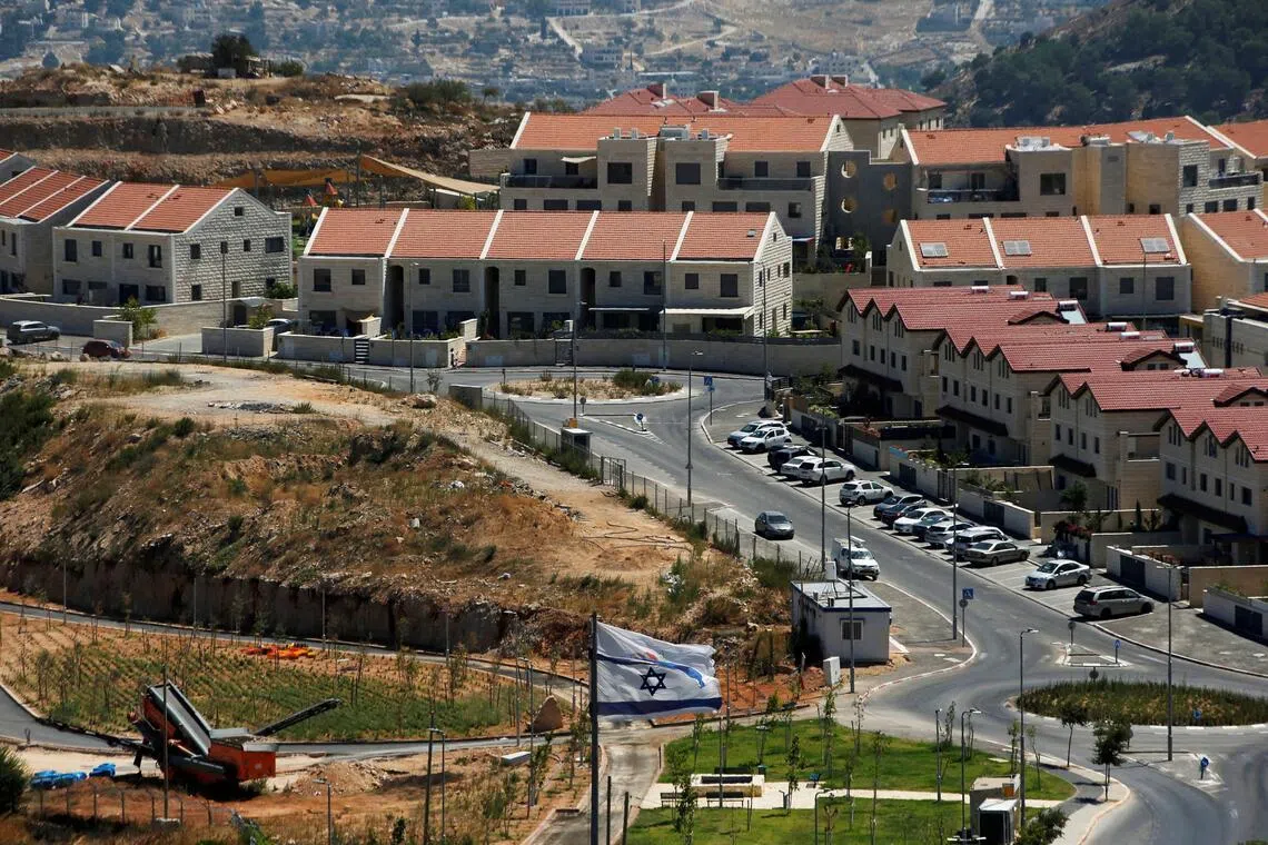 A 2020 photo shows the Israeli national flag fluttering in the Israeli settlement of Efrat, in the Israeli-occupied West Bank.
