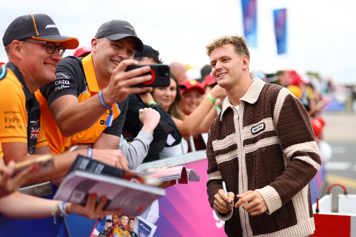 Formula One F1 - British Grand Prix - Silverstone Circuit, Silverstone, Britain - July 5, 2025 Alpine reserve driver Mick Schumacher takes photograph with fans ahead of practice REUTERS/Andrew Boyers