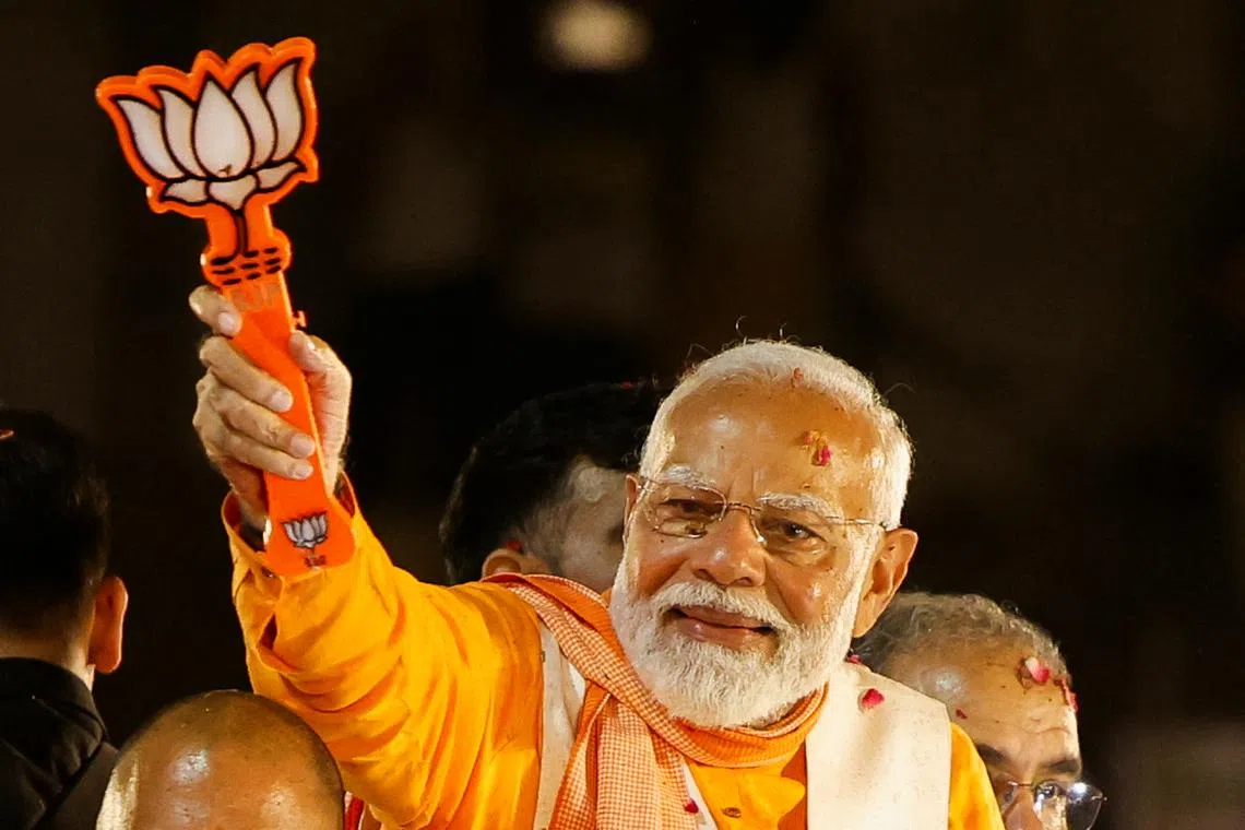 FILE PHOTO: India's Prime Minister Narendra Modi shows the Bharatiya Janata Party (BJP) symbol during a roadshow as part of an election campaign, in Varanasi, India, May 13, 2024. REUTERS/Adnan Abidi/File Photo