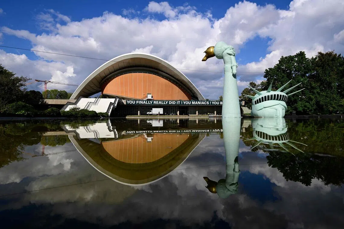 An inflatable replica of the Statue of Liberty is submerged in a pool in front of the House of World Cultures
, an art center in Berlin on Sept 29, 2025, as part of the exhibition "Possibility of Unvernunft".