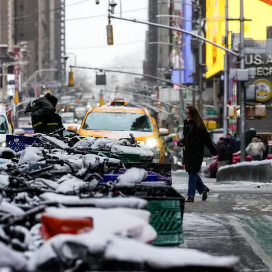 People making their way during a snowfall at Times Square in New York City, on Dec 14..