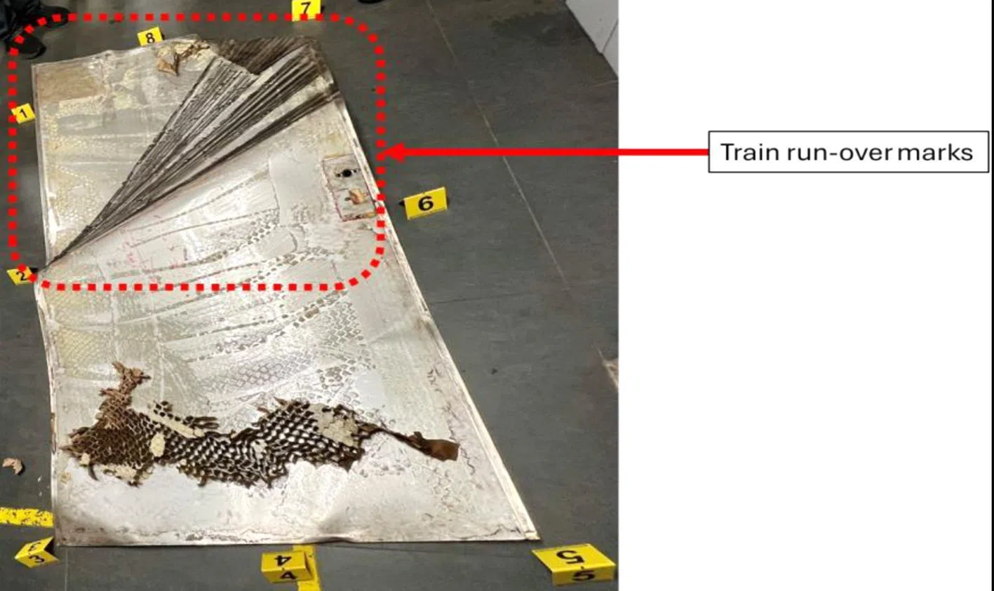 Train run-over marks on the metal cladding retrieved from the track.